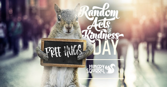 Squirrel holding small board with text: free Hugs. "Random Acts of Kindness Day"