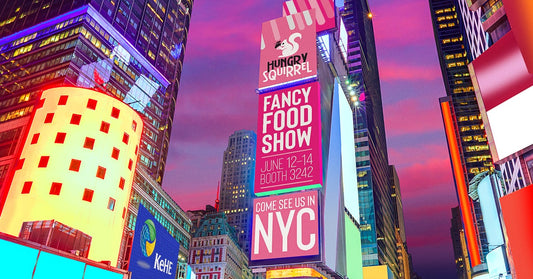 Time square billboards, text: Hungry Squirrel| Fancy food show, june 12-14 booth 3242. Come see us in NYC