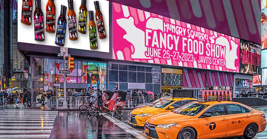 Ads outside new york building. Hungry Squirrel sauces. text" Fancy Food Show, June 25-27, Javits Center