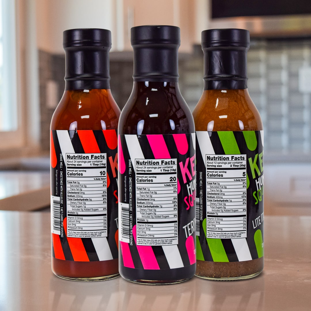 Everyday Essentials Bundle Including Lite Italian Dressing, Ketchup and Teriyaki Sauce Products on top a kitchen counter - Back of Bottles - for nutritional info please read individual product description